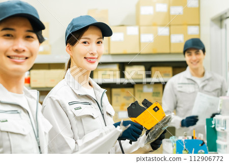 Young staff doing light work in the backyard 112906772