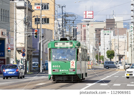 [Logo and number driver blurred] Hakodate streetcar wrapping train runs 112906981