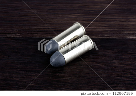 Ammunition on wooden background. 112907199