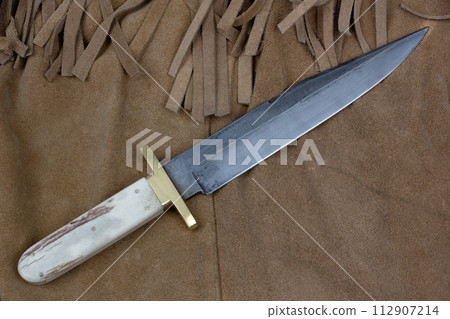 Old west bowie knife on leather jacket 112907214