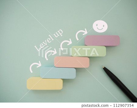 Arrow going up steps and level up text 112907354