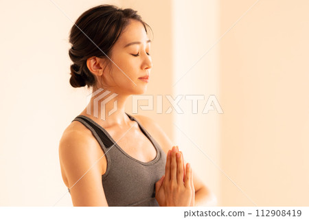 Young lady playing hot yoga Young lady playing hot yoga 112908419