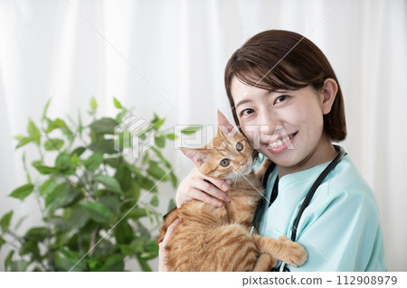 A female veterinarian holding a Chatora kitten A female veterinarian holding a Chatora kitten 112908979