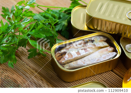 Preserved mackerel fish on wooden table Preserved mackerel fish on wooden table 112909410