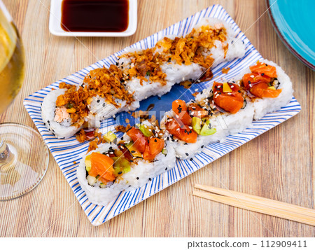 Popular Japanese dish is Uramaki rolls and Saketaki rolls Popular Japanese dish is Uramaki rolls and Saketaki rolls 112909411