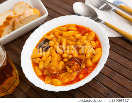 Traditional dish of Spanish cuisine is Fabada soup 112909487