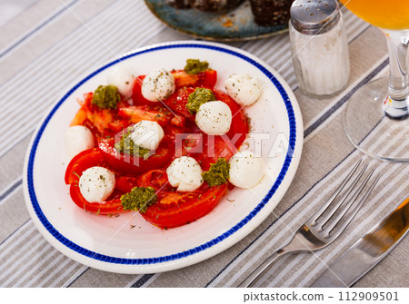Caprese salad with tomato, mozzarella and balsamic dressing Caprese salad with tomato, mozzarella and balsamic dressing 112909501