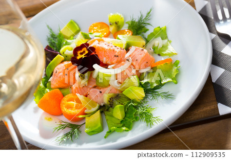 Ceviche of trout with avocado, cumquat, greens Ceviche of trout with avocado, cumquat, greens 112909535