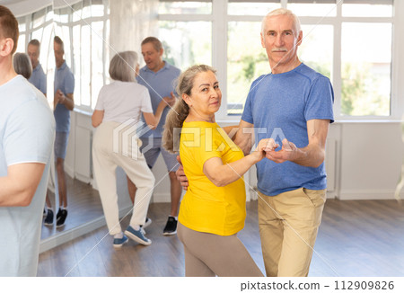 Senior woman practicing passionate samba with man in dance class 112909826