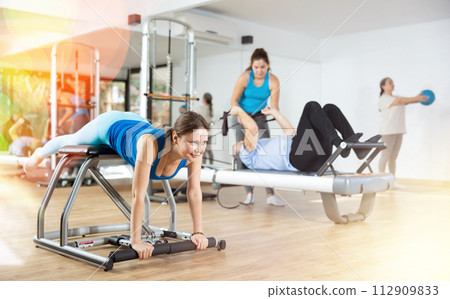 Woman doing exercises on wunda chair in pilates studio 112909833