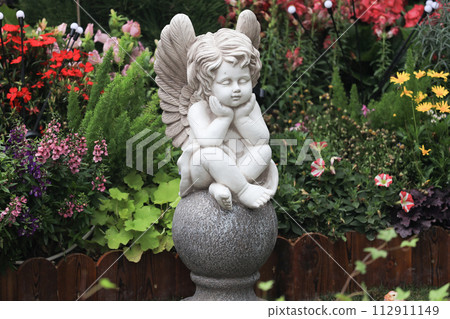 the Statue child angle among pink flower. 112911149