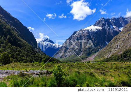 Beautiful blue sky and snowy mountains near Milford Sound on a sunny summer day Beautiful blue sky and snowy mountains near Milford Sound on a sunny summer day 112912011