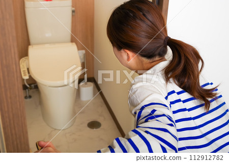 A woman who has a stomach ache and relieves herself A woman who has a stomach ache and relieves herself 112912782