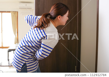 A woman who has a stomach ache and relieves herself 112912784