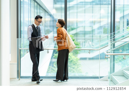 Business people talking in the office lobby 112912854