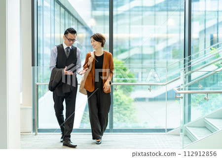 Business people talking in the office lobby Business people talking in the office lobby 112912856