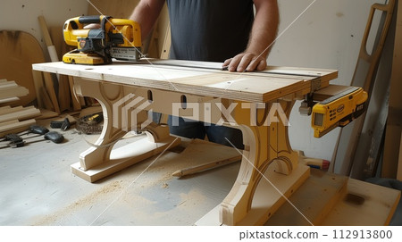 worker in a carpentry workshop inside a carpentry workshop 112913800