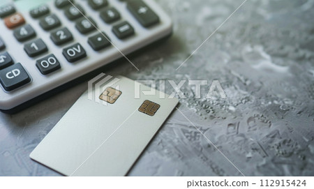Cash card and calculator placed on a calculator 112915424