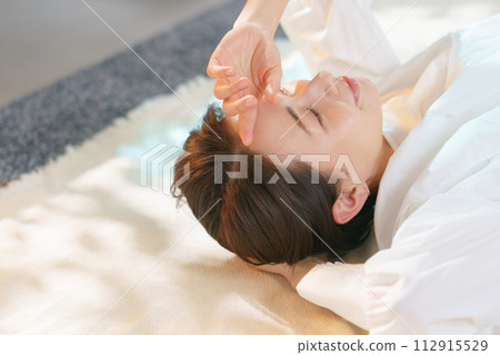 A woman taking a nap looking comfortable 112915529