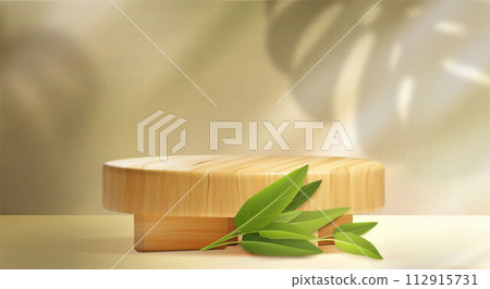 Wooden cylinder product podium with green leave 112915731