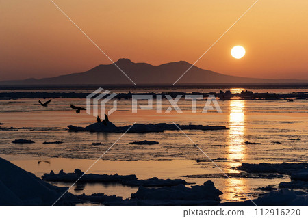 Sunrise and drift ice from Kunashir Island Sunrise and drift ice from Kunashir Island 112916220