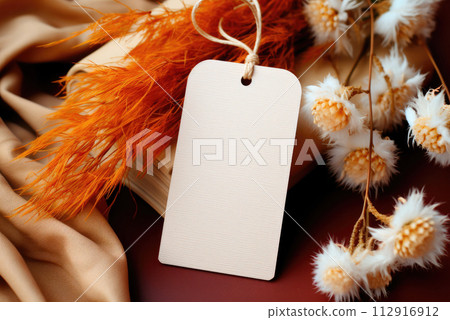 Craft label or tag on the background of an autumn bouquet of flowers 112916912