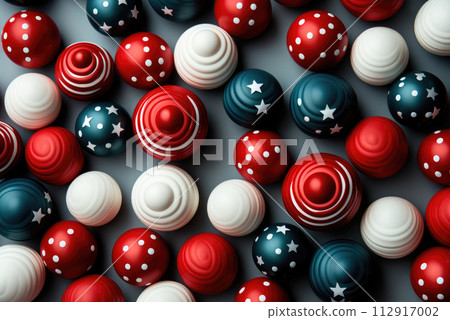 Concept of celebrating America's Independence Day. Top view flat pattern image in the colors of the national flag of blue, red, white balls with stars on a blue background Concept of celebrating America's Independence Day. Top view flat pattern image in the colors of the national flag of blue, red, white balls with stars on a blue background 112917002