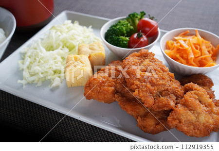 Japanese lunch plate with delicious chicken cutlet and plenty of vegetables Japanese lunch plate with delicious chicken cutlet and plenty of vegetables 112919355