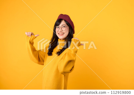 young Asian woman in her 30s, wearing a yellow shirt and red beret. happy face and pointing finger to free copy space against vibrant yellow backdrop. Unlock savings and shop now! young Asian woman in her 30s, wearing a yellow shirt and red beret. happy face and pointing finger to free copy space against vibrant yellow backdrop. Unlock savings and shop now! 112919800