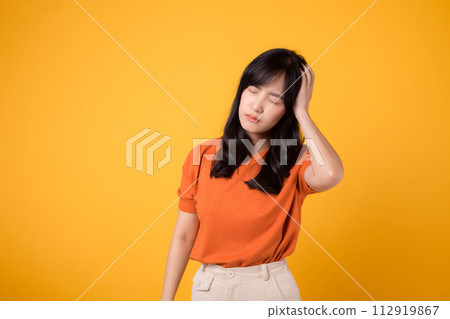 Capture the complexity of emotions with a portrait of a stressed woman, her face revealing pain, sadness, and tension. isolated on yellow background. Capture the complexity of emotions with a portrait of a stressed woman, her face revealing pain, sadness, and tension. isolated on yellow background. 112919867