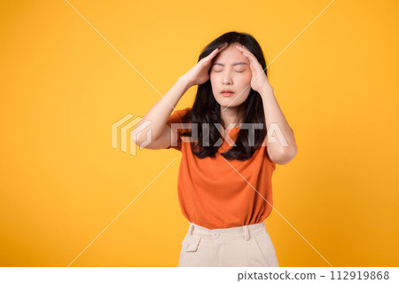 Asian woman distressed expression captures the realities of stress, headache, and discomfort, reflecting her emotional state. Asian woman distressed expression captures the realities of stress, headache, and discomfort, reflecting her emotional state. 112919868