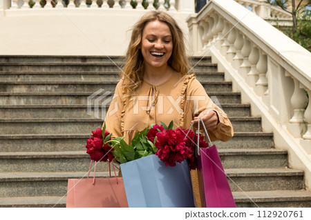 Young girl with paper bags, with flowers. Young girl with paper bags, with flowers. 112920761