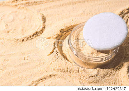 A bottle of light-colored powder on a yellow background. A bottle of light-colored powder on a yellow background. 112920847