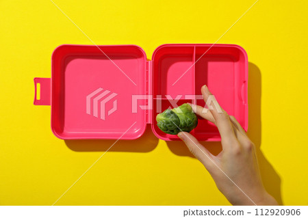 Pink lunch box on a yellow background 112920906