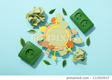 Paper model of the Earth with green electric sockets 112920937