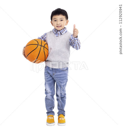 Happy asian Boy  holding a basketball and showing thumbs up isolated on white background 112920941