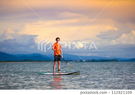 Man on stand up paddle. Water and beach sport 112921109
