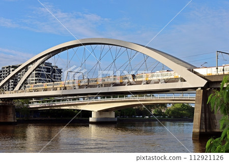 沐浴在早晨陽光下的火車和桁架橋 112921126