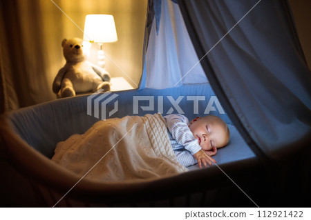 Baby boy in bed sleeping at night Baby boy in bed sleeping at night 112921422