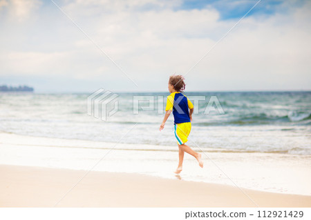 Kids playing on beach. Children play at sea. 112921429