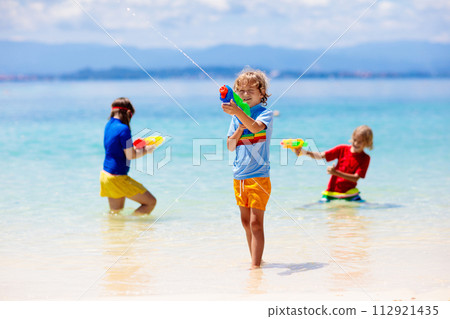 Child with toy water gun. Kids vacation beach fun. Child with toy water gun. Kids vacation beach fun. 112921435