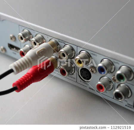 Two RCA plugs connected to output video slots of multimedia player rear panel Two RCA plugs connected to output video slots of multimedia player rear panel 112921519