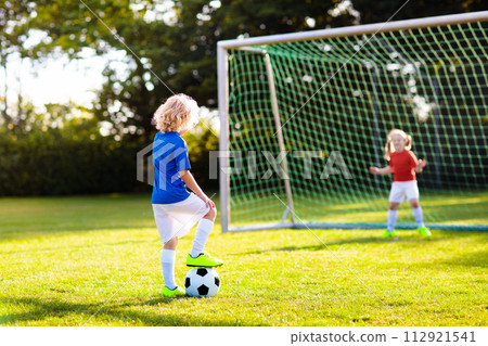 Kids play football. Child at soccer field. Kids play football. Child at soccer field. 112921541