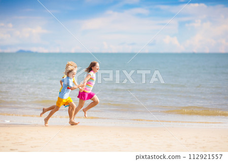 Kids play on tropical beach. Sand and water toy. 112921557