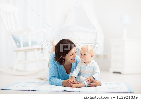 Mother and baby playing on the floor Mother and baby playing on the floor 112921839