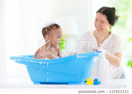 Baby boy in bath. Mother washing infant child. Baby boy in bath. Mother washing infant child. 112922211