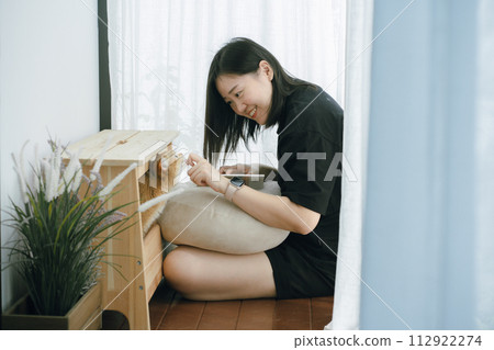 pet care concept with owner during read book and play with british cat in livingroom 112922274