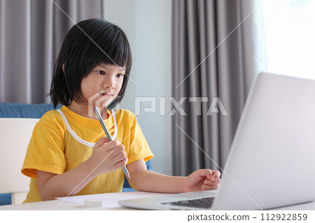 little asian girl student study online using laptop computer at home 112922859