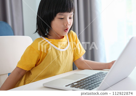 little asian girl student study online using laptop computer at home 112922874