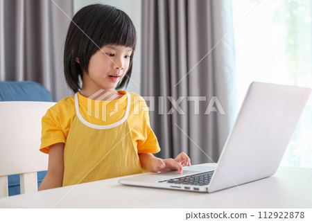 little asian girl student study online using laptop computer at home 112922878